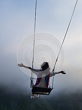 Freedom and carefree of a young female on a swing