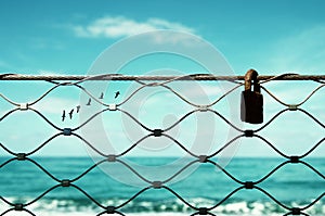 freedom concept. image fence and old rusty lock and birds flying in the horizon. everything is possible.