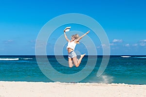 Freedom concept. woman on a beach of Bali island. She is enjoying serene ocean nature during travel holidays