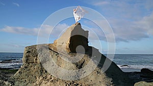 Freedom Concept . Women in white dress and with scarf standing on the Rock. Dancing. Flying. Moving.