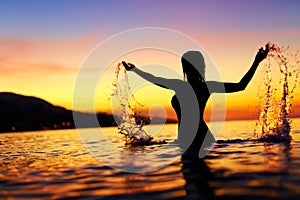 Freedom, Enjoyment. Woman In Sea At Sunset. Happiness, Healthy L