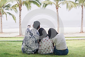 Freedom family on the beach. Mother, daughter and father against sea and sky background. Happy holiday travel concept