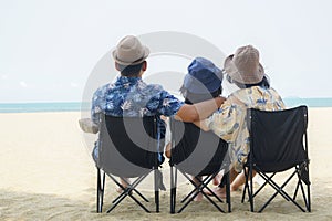 Freedom family on the beach. Mother, daughter and father against sea and sky background. Happy holiday travel concept