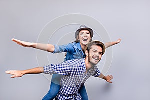 Freedom and fun, emotions and feelings. Cheerful and playful couple in casual outfits and hats are fooling around, gesturing plan