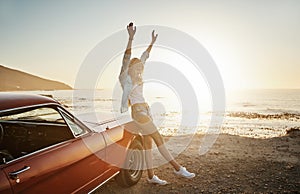 Freedom is fun. a young woman enjoying a road trip along the coast.