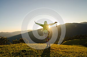 Freedom girl with hands up in the mountains