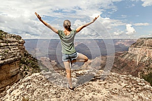 Freedom Girl with hands up on top of the Mountain