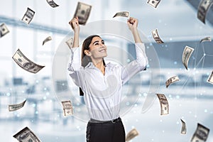 Freedom, money, wealth and busines success concept with happy woman on background under dollar banknotes rain