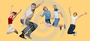 Freedom in moving. young man and women jumping against yellow background