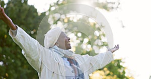 Freedom, nature and happy senior woman in a park for breathing, celebration or travel adventure. Retirement, energy and