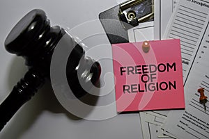 Freedom of Religion text on sticky notes and gavel  on office desk. Law concept