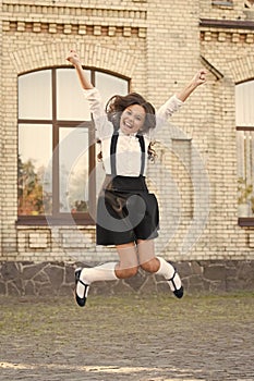 Freedom. schoolgirl in classy retro uniform. old school. back to school. childhood happiness. classy uniform market