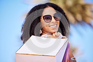Freedom, summer and girl with shopping bag portrait and smile in sunny Los Angeles, USA. Happy, consumerism and trendy