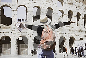 Freedom  of  young Woman tourist with map at Rome in front of Colosseum, Italy