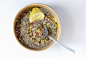 Freekeh, pomegranate seeds and pistachio healthy salad. Arabic and African traditional cusion. Copy space. White background photo
