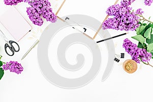 Freelance of blogger workspace with clipboard, notebook, scissors, lilac and accessories on white background. Flat lay, top view.