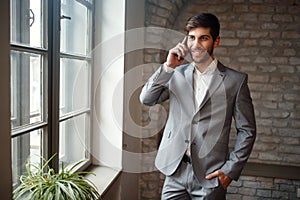 Freelance businessman in suit talking on smartphone