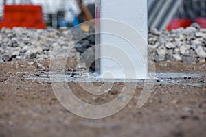 A freelance clown creating balloon animals and different shapes at outdoor festival in city center.Industrial construction site of