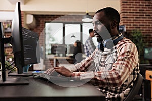Freelance coder typing javascript code on computer
