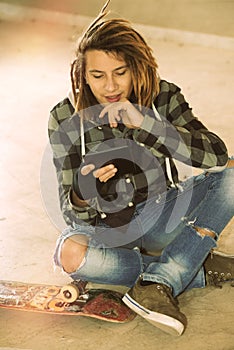 Freelance dreadlocks guy sitting with digital tablet warm filte