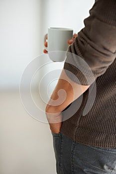 Freelance, hands and closeup of man on coffee break in his home, relax and enjoying peaceful moment. Remote work