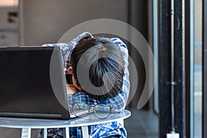 Freelance man working with laptop and sleeping