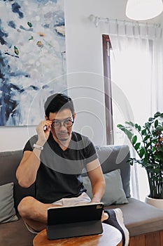 Freelance man working online in the cafe with his tablet.