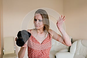 Freelance photographer woman with camera at home office editing photos on a computer