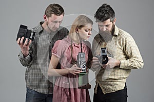 Freelance photographers. Paparazzi or photojournalists with vintage old cameras. Group of people with retro cameras