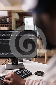 Freelance programmer working remote writing code for software on pc using keyboard debugging algorithm