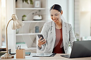 Freelance and remote working business woman checking her phone, reading a message or sending a text in her home office