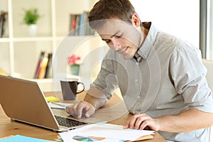 Freelance worker working at home reading documents photo
