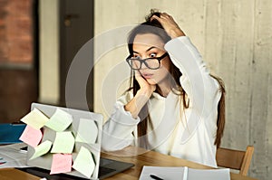 Freelance young woman shocked by tasks, searches information