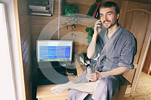 Freelancer in bathrobe work from home in quarantine, talking on smartphone and smile, lifestyle workplace or workplace