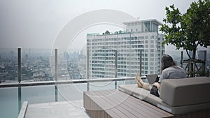 Freelancer Businessman Is Working With His Computer Laptop In A Luxury Hotel In Bangkok, Thailand. Static Shot