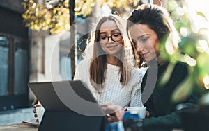 Freelancer communicate on project, friends shopping online on wifi tablet in cafe outdoor. Students studies on internet. Working