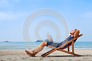 Freelancer, happy successful businessman on the beach