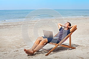 Freelancer with laptop on the beach, successful happy business man relaxing
