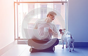 Freelancer man using laptop computer and cup of coffee