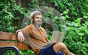 Freelancer man working on computer. Businessman using notebook in park. Escaped of office. successful entrepreneur