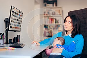 Freelancer Mother Working From Home Holding Baby