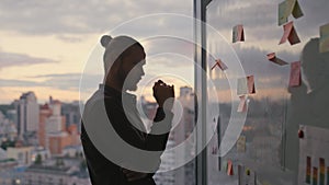 Freelancer silhouette reading notes sunset office closeup. Unknown man pondering