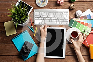 Freelancer sitting at desk and tablet computer