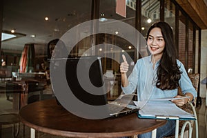 Freelancer woman working using laptop with thumbs up hand gesture