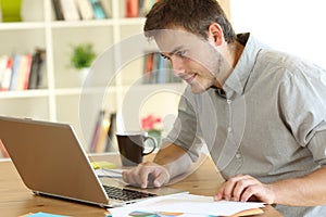 Freelancer working checking on line content at home photo