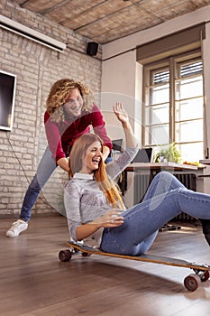 Freelancers riding a scate board at the office