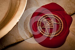 Freemason secret symbol concept with vintage letter under a candle, sealed with red wax seal with the square, the compass and the