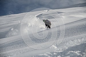 Freerider glides down the mountain side covered in snow
