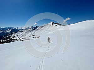 Freerider hiking in the Austrian Alps in spring. Vorarlberg, Austria.