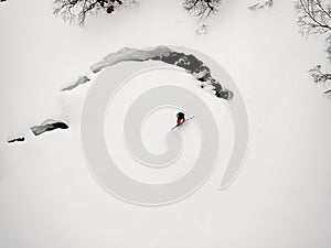 Freerider skier lost his balance and fell into the snow during the descent